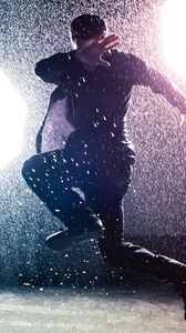 Preview wallpaper man, jump, rain, light