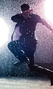 Preview wallpaper man, jump, rain, light