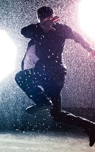 Preview wallpaper man, jump, rain, light