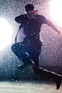 Preview wallpaper man, jump, rain, light