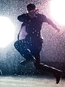 Preview wallpaper man, jump, rain, light