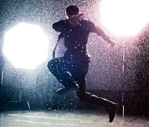 Preview wallpaper man, jump, rain, light