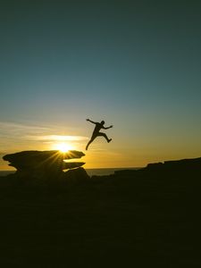 Preview wallpaper man, jump, rocks, sunset