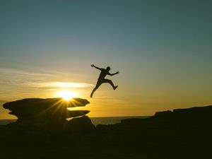 Preview wallpaper man, jump, rocks, sunset