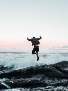 Preview wallpaper man, jump, waves, stones, sea