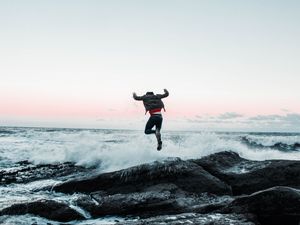 Preview wallpaper man, jump, waves, stones, sea