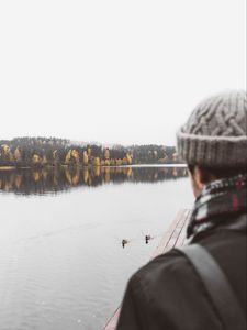 Preview wallpaper man, lake, sad, shore, pier, nature