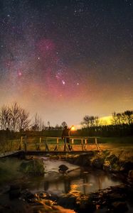 Preview wallpaper man, lantern, bridge, night, starry sky, dark