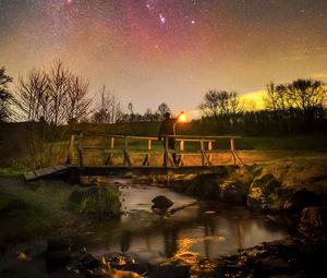 Preview wallpaper man, lantern, bridge, night, starry sky, dark