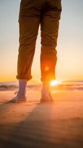 Preview wallpaper man, legs, beach, sun, sunset, glare