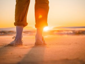 Preview wallpaper man, legs, beach, sun, sunset, glare