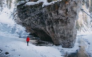 Preview wallpaper man, loneliness, alone, rocks, snowy