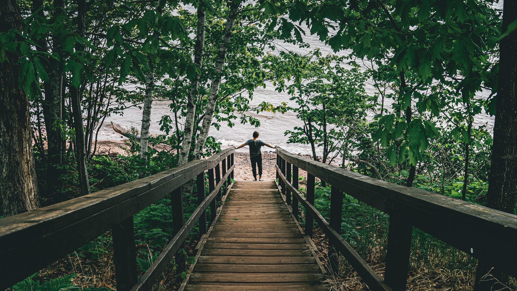 Download wallpaper 2048x1152 man, loneliness, alone, stairs, coast