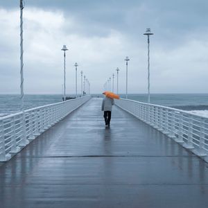 Preview wallpaper man, loneliness, alone, pier, umbrella