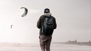 Preview wallpaper man, loneliness, alone, style, paragliders, coast
