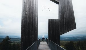 Preview wallpaper man, loneliness, alone, architecture, construction, wooden