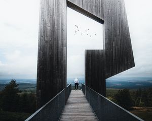 Preview wallpaper man, loneliness, alone, architecture, construction, wooden