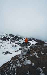 Preview wallpaper man, loneliness, solitude, snow, stones, fog