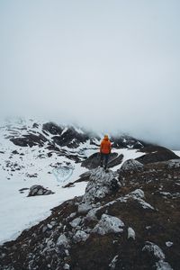 Preview wallpaper man, loneliness, solitude, snow, stones, fog