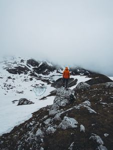 Preview wallpaper man, loneliness, solitude, snow, stones, fog