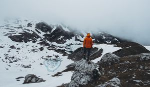 Preview wallpaper man, loneliness, solitude, snow, stones, fog