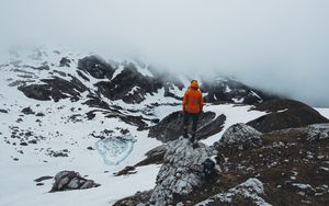 Preview wallpaper man, loneliness, solitude, snow, stones, fog