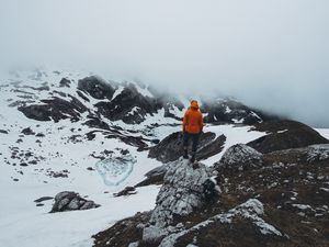 Preview wallpaper man, loneliness, solitude, snow, stones, fog
