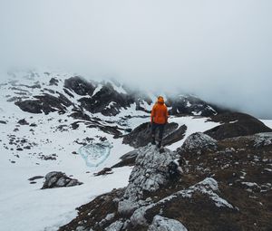 Preview wallpaper man, loneliness, solitude, snow, stones, fog