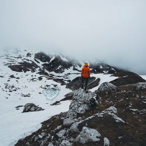 Preview wallpaper man, loneliness, solitude, snow, stones, fog