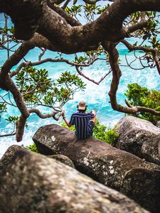 Preview wallpaper man, loneliness, stones, sea, solitude