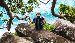 Preview wallpaper man, loneliness, stones, sea, solitude