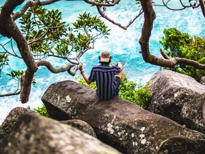 Preview wallpaper man, loneliness, stones, sea, solitude