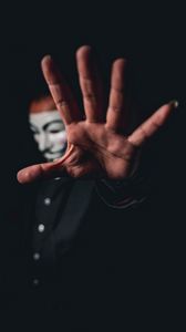 Preview wallpaper man, mask, anonymous, hand, gesture