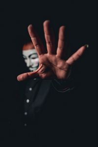 Preview wallpaper man, mask, anonymous, hand, gesture