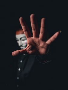 Preview wallpaper man, mask, anonymous, hand, gesture