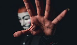 Preview wallpaper man, mask, anonymous, hand, gesture