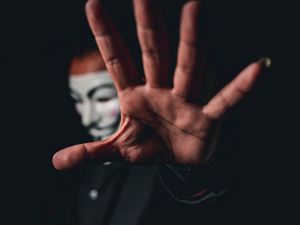 Preview wallpaper man, mask, anonymous, hand, gesture