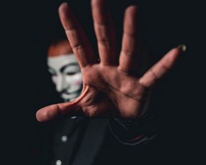 Preview wallpaper man, mask, anonymous, hand, gesture