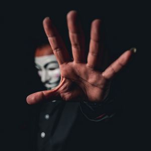Preview wallpaper man, mask, anonymous, hand, gesture