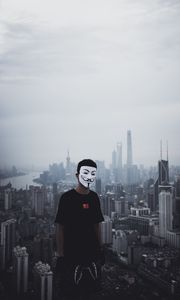 Preview wallpaper man, mask, city, buildings, view, overview