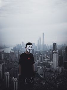 Preview wallpaper man, mask, city, buildings, view, overview