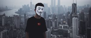 Preview wallpaper man, mask, city, buildings, view, overview