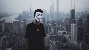 Preview wallpaper man, mask, city, buildings, view, overview