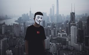 Preview wallpaper man, mask, city, buildings, view, overview