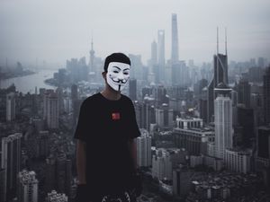 Preview wallpaper man, mask, city, buildings, view, overview