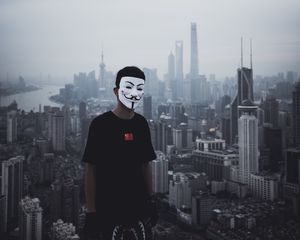 Preview wallpaper man, mask, city, buildings, view, overview