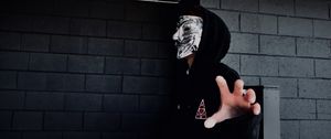 Preview wallpaper man, mask, hand, touch