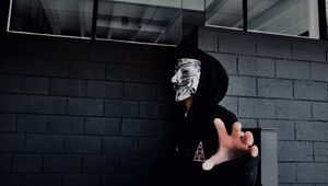 Preview wallpaper man, mask, hand, touch