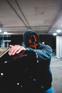 Preview wallpaper man, mask, hood, hand