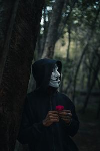 Preview wallpaper man, mask, hood, anonymous, forest